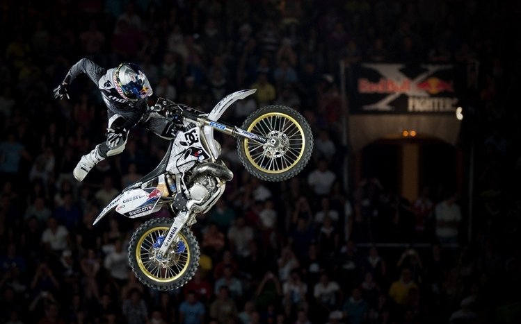 Download Motocross Rider Kneeling Jump Wallpaper | Wallpapers.com